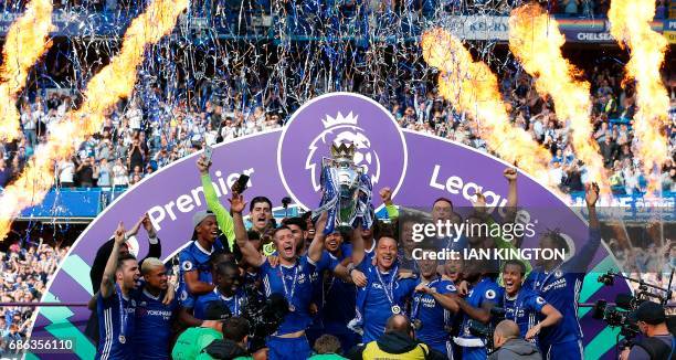 Chelsea's English defender Gary Cahill and Chelsea's English defender John Terry hold up the Premier League trophy, as players celebrate their league...