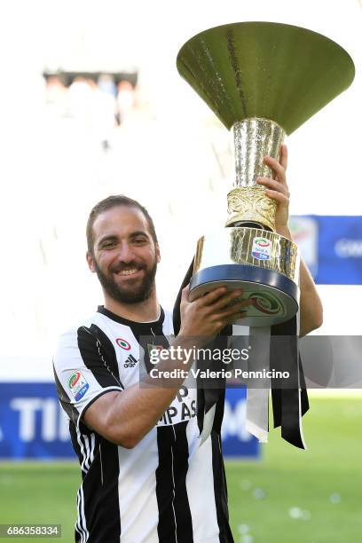 Gonzalo Higuain of Juventus FC celebrates with the trophy after the beating FC Crotone 3-0 to win the Serie A Championships at the end of the Serie A...