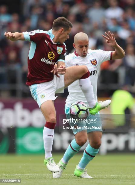 Sofiane Feghouli of West Ham United and Ashley Westwood of Burnley battle for possession during the Premier League match between Burnley and West Ham...