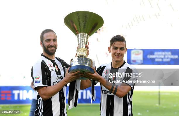 Gonzalo Higuain and Paulo Dybala of Juventus FC celebrate with the trophy after the beating FC Crotone 3-0 to win the Serie A Championships at the...