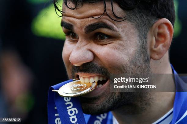 Chelsea's Brazilian-born Spanish striker Diego Costa poses with his winner's medal, as players celebrate their league title win at the end of the...