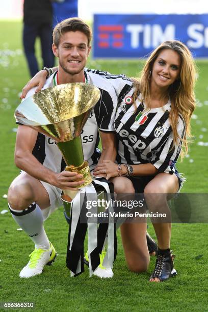 Daniele Rugani of Juventus FC and Michela Persico celebrate with the trophy after the beating FC Crotone 3-0 to win the Serie A Championships at the...