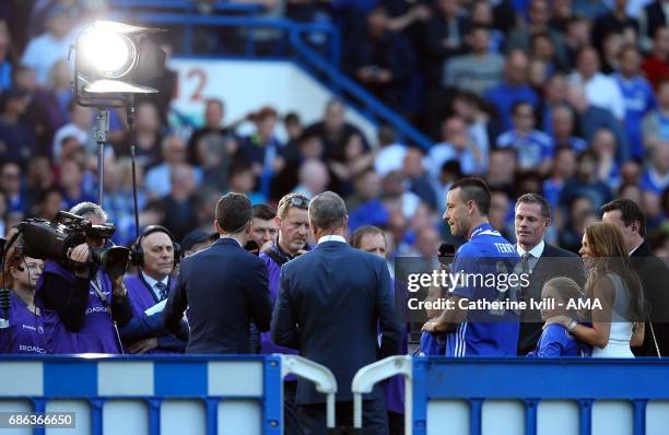 John Terry of Chelsea stands with his family as he is interviewed by Sky Sports television after the Premier League match between Chelsea and...