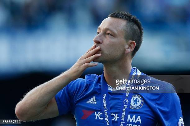 Chelsea's English defender John Terry salutes the crowd at the end of the presentation ceremony for the English Premier League trophy at the end of...