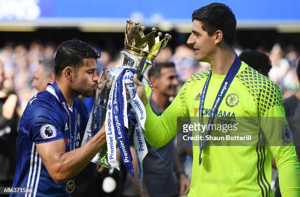 Diego Costa of Chelsea and Thibaut Courtois of Chelsea celebrate with the Premier League Trophy after the Premier League match between Chelsea and...