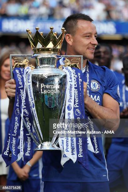 John Terry of Chelsea poses with his winners medal and the Premier League trophy at the end of the Premier League match between Chelsea and...
