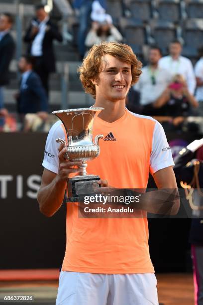 Alexander Zverev of Germany poses for a photo with his trophy after winning the Men's Single Final match against Novak Djokovic of Serbia during day...