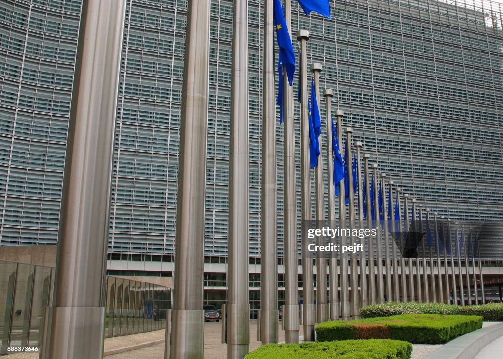 European Commission building in Brussels, Belgium an EU flag