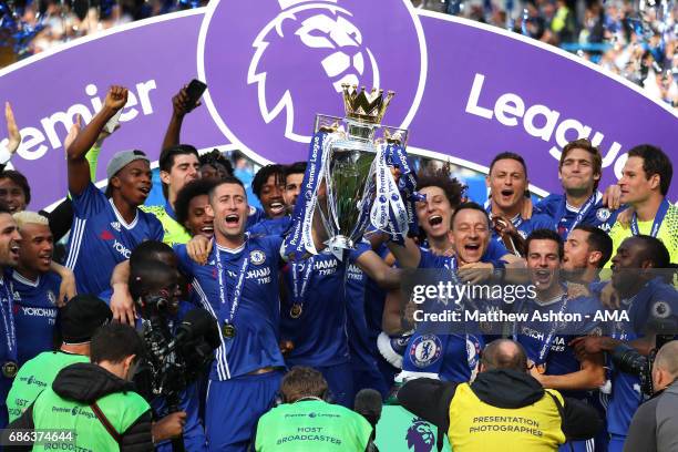 John Terry and Gary Cahill of Chelsea lift the Premier League trophy as their team-mates celebrate at the end of the Premier League match between...