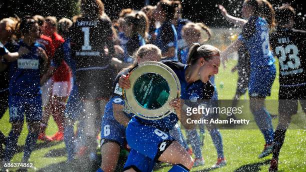 Annika Eberhardt of Hoffenheim II is sprayed with champagne while celebrating with the Bundesliga II trophy after victory in the match between 1899...