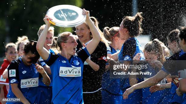 Annika Eberhardt of Hoffenheim II is sprayed with champagne while celebrating with the 2. Bundesliga Womens trophy after victory in the match between...