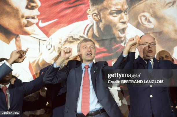 Monaco's Russian president Dmitriy Rybolovlev and Prince Albert II of Monaco acknowledge fans on May 21, 2017 in Monaco, during a celebration to mark...