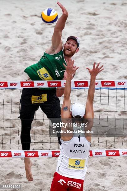 Alison Cerutti of Brazil spikes the ball during the Men's Finals match against Piotr Kantor and Bartosz Losiak of Poland at Olympic Park during day...