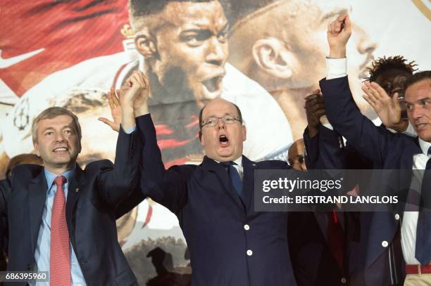 Monaco's club's Russian president Dmitriy Rybolovlev and Prince Albert II of Monaco acknowledge their fans on May 21, 2017 in Monaco, during a...