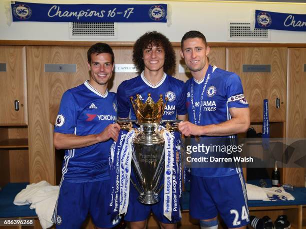 Cesar Azpilicueta of Chelsea, David Luiz of Chelsea and Gary Cahill of Chelsea pose with the Premier League Trophy in the changing room after the...