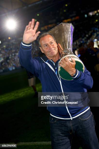 Head coach Huub Stevens of Schalke does a lap of honour with the Uefa Cup trophy after the 20 years of Eurofighter match between Eurofighter and...