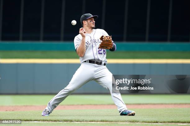 Nolan Arenado of the Colorado Rockies gets hit in the face trying to field the ball in the first inning of a game against the Cincinnati Reds at...