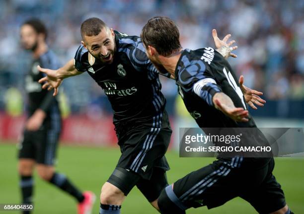 Real Madrid's French forward Karim Benzema celebrates a goal with Real Madrid's defender Sergio Ramos during the Spanish league football match Malaga...