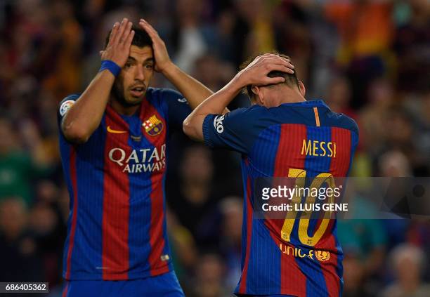 Barcelona's Argentinian forward Lionel Messi and Barcelona's Uruguayan forward Luis Suarez gesture during the Spanish league football match FC...