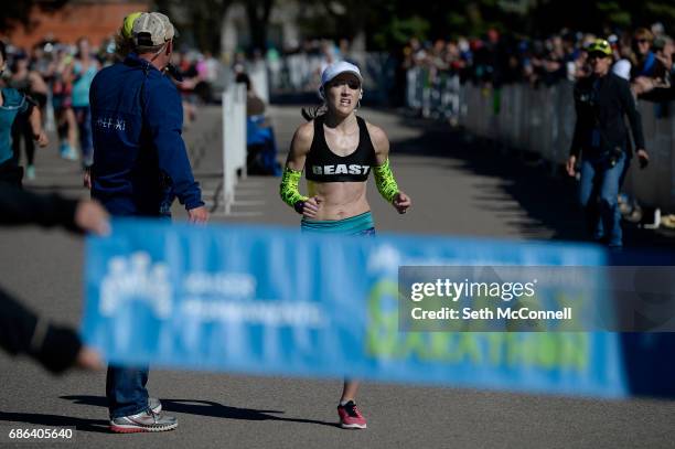 Brittany Lee crosses the finish line in first during the Colfax Marathon at City Park on May 21 in Denver, Colorado. The 12th annual Colfax Marathon...