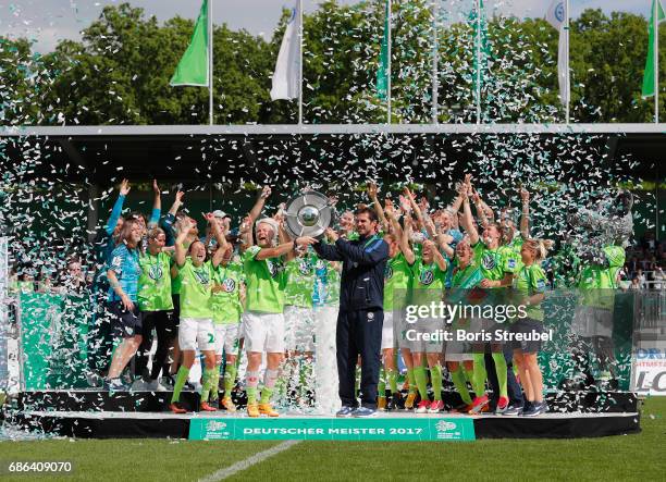 Nilla Fischer of VfL Wolfsburg and head coach Ralf Kellermann of VfL Wolfsburg lift the Championship trophy in celebration of the German Championship...