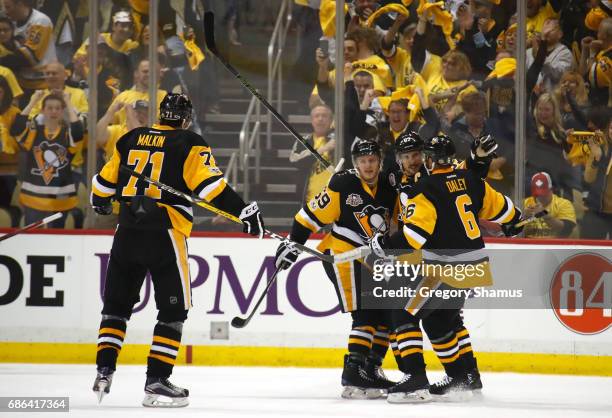 Sidney Crosby of the Pittsburgh Penguins celebrates with his teammates after scoring a goal against Craig Anderson of the Ottawa Senators during the...