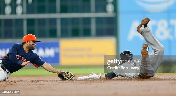 Jose Altuve of the Houston Astros dives but unable to beat Yan Gomes of the Cleveland Indians to the base in the second inning at Minute Maid Park on...