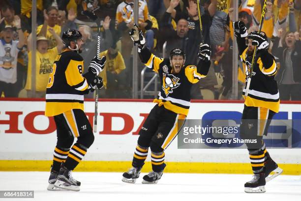 Nick Bonino of the Pittsburgh Penguins celebrates with teammates Brian Dumoulin and Carter Rowney after Bryan Rust , scored a goal against Craig...
