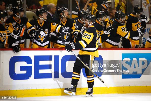 Scott Wilson of the Pittsburgh Penguins celebrates with his teammates after scoring a goal against Craig Anderson of the Ottawa Senators during the...