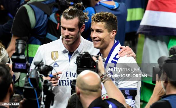 Real Madrid's Portuguese forward Cristiano Ronaldo and Real Madrid's Welsh forward Gareth Bale pose after winning the Liga title after the Spanish...