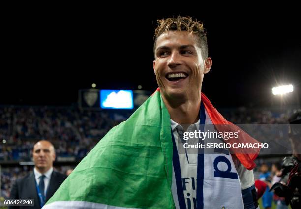 Real Madrid's Portuguese forward Cristiano Ronaldo smiles as he celebrates at the end of the Spanish league football match Malaga CF vs Real Madrid...