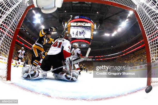 Carter Rowney of the Pittsburgh Penguins celebrates after Bryan Rust scored a goal against Craig Anderson of the Ottawa Senators during the first...