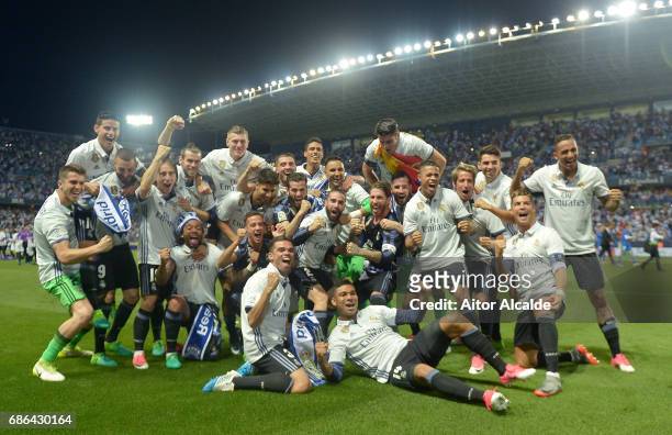 The Real Madrid squad celebrate winning the La Liga title following the La Liga match between Malaga and Real Madrid at La Rosaleda Stadium on May...
