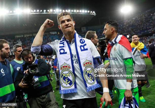 Cristiano Ronaldo of Real Madrid celebrates after his side are crowned champions following the La Liga match between Malaga and Real Madrid at La...