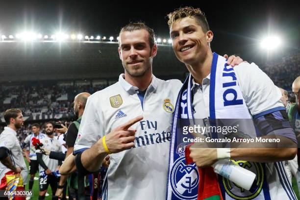 Cristiano Ronaldo of Real Madrid and Gareth Bale of Real Madrid celebrate after their team are crowned champions following the La Liga match between...