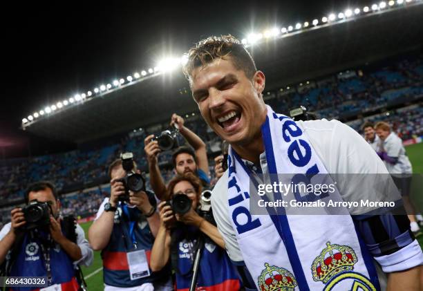 Cristiano Ronaldo of Real Madrid celebrates after his side are crowned champions following the La Liga match between Malaga and Real Madrid at La...