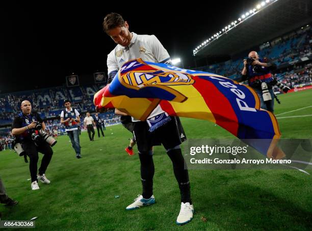 Sergio Ramos of Real Madrid celebrates after his side are crowned champions following the La Liga match between Malaga and Real Madrid at La Rosaleda...