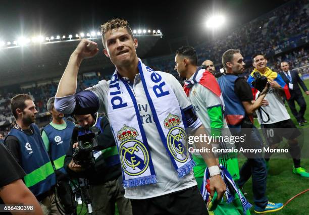 Cristiano Ronaldo of Real Madrid celebrates after his side are crowned champions following the La Liga match between Malaga and Real Madrid at La...