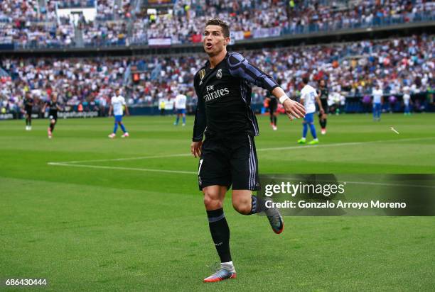 Cristiano Ronaldo of Real Madrid celebrates after he scores his sides first goal during the La Liga match between Malaga and Real Madrid at La...