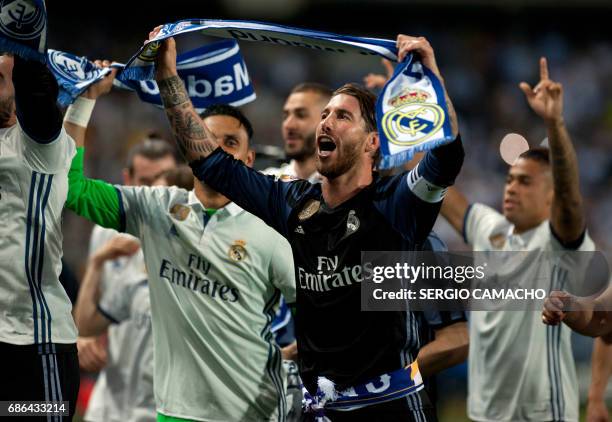 Real Madrid's defender Sergio Ramos celebrates with teammates at the end of the Spanish league football match Malaga CF vs Real Madrid at La Rosaleda...