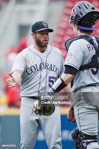 Greg Holland and Ryan Hanigan of the Colorado Rockies celebrate after the final out in the ninth inning of a game against the Cincinnati Reds at...