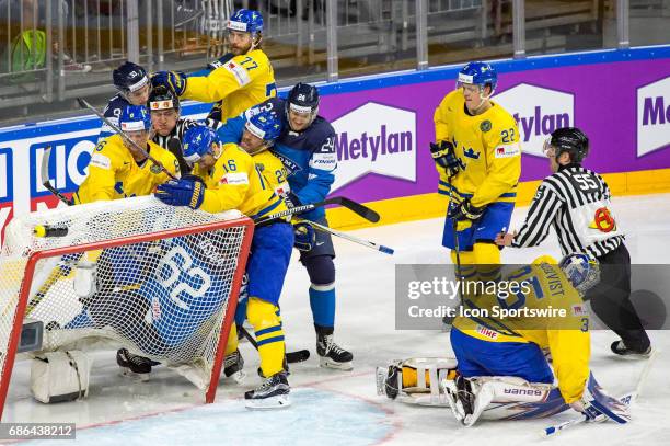 Oskar Osala fights with Marcus Kruger during the Ice Hockey World Championship Semifinal between Sweden and Finland at Lanxess Arena in Cologne,...