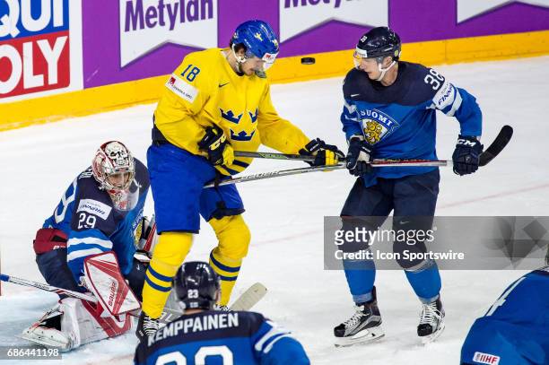 Dennis Everberg tries to score against Juuso Hietanen and Goalie Harri Sateri during the Ice Hockey World Championship Semifinal between Sweden and...