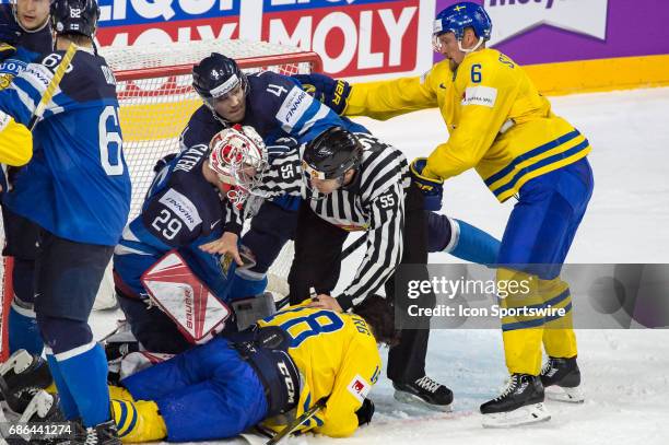 Dennis Everberg fights with Goalie Harri Sateri and Mikko Lehtonen during the Ice Hockey World Championship Semifinal between Sweden and Finland at...