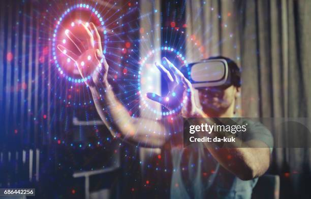browsing a virtual world in virtual reality glasses - simulation stock pictures, royalty-free photos & images