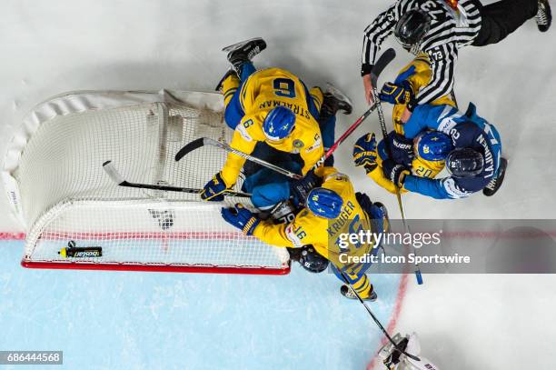 Oskar Osala fights with Anton Stralman and Marcus Kruger during the Ice Hockey World Championship Semifinal between Sweden and Finland at Lanxess...