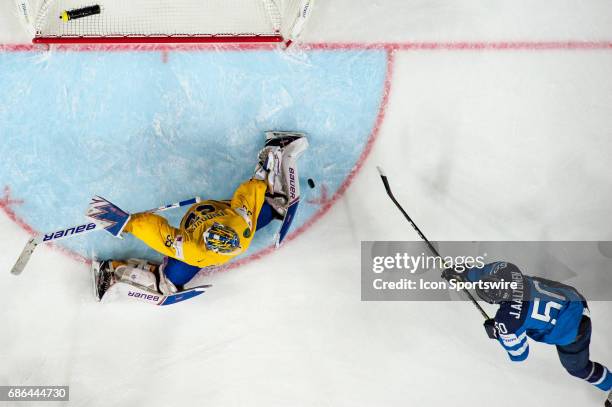 Juhamatti Aaltonen tries to score against Goalie Henrik Lundqvist during the Ice Hockey World Championship Semifinal between Sweden and Finland at...