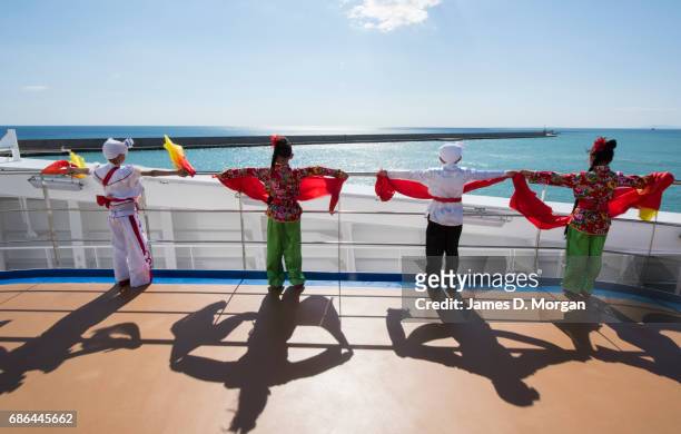 Girls and boys from the Luochuan Yangko dance troupe and Ansai waist drum troupe, Yan'an city, Shaanxi province, China performing aboard Princess...
