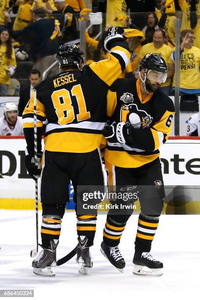 Trevor Daley of the Pittsburgh Penguins celebrates with his teammate Phil Kessel after scoring a goal against Mike Condon of the Ottawa Senators...