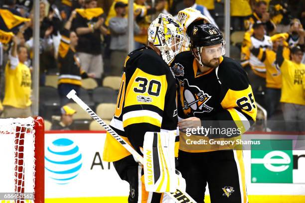 Matt Murray of the Pittsburgh Penguins celebrates with his teammate Ron Hainsey after defeating the Ottawa Senators with a score of 7 to 0 in Game...